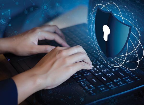 Endpoint Protection shield securing a business laptop for remote work.